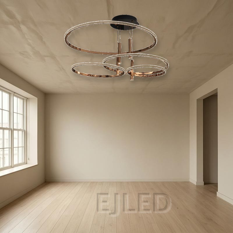 This multi-ring LED ceiling light features four graduated rings in a polished rose gold finish suspended from a round black canopy. - view 4