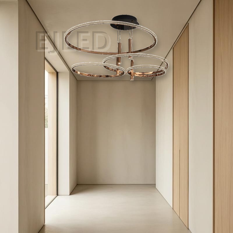 This multi-ring LED ceiling light features four graduated rings in a polished rose gold finish suspended from a round black canopy. - view 5