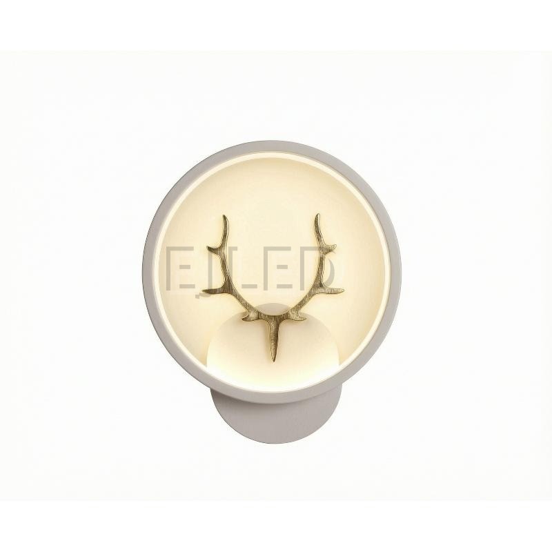 This modern antler LED wall light features a circular shade with a gold finish deer motif, providing warm illumination for hospitality and residential interior projects.