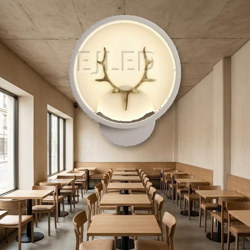 This modern antler LED wall light features a circular shade with a gold finish deer motif, providing warm illumination for hospitality and residential interior projects. - view 5