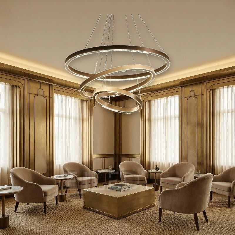 Three nested aluminum rings suspend at staggered angles from adjustable steel cables, combining brushed metallic finishes with continuous internal LED illumination. - view 5