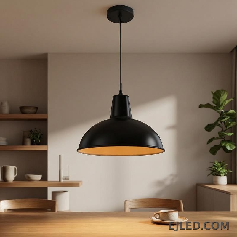 The MK0001 barn pendant light features a robust steel dome shade with a matte black exterior and a white interior, directing downward light from a single lamp. It suspends from a matching black cord and canopy. - view 4
