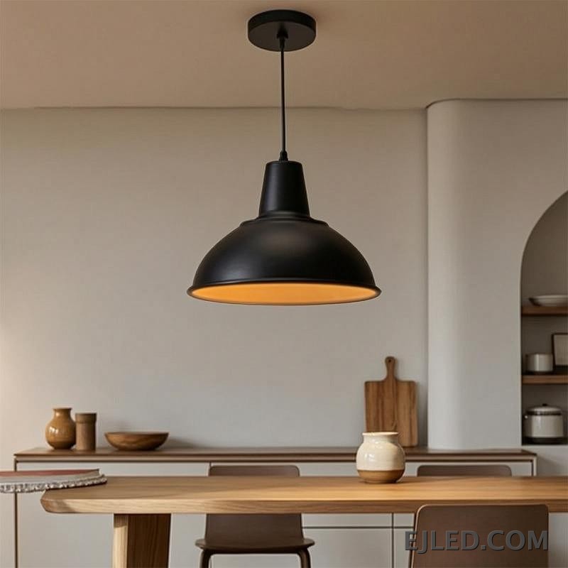The MK0001 barn pendant light features a robust steel dome shade with a matte black exterior and a white interior, directing downward light from a single lamp. It suspends from a matching black cord and canopy. - view 5