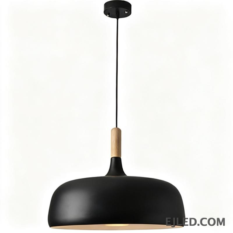 The MK0005 barn pendant light is a classic bell-shaped fixture with a matte black metal exterior and a white interior. It provides focused downward illumination from a single lamp, suspended by a black cable and canopy.