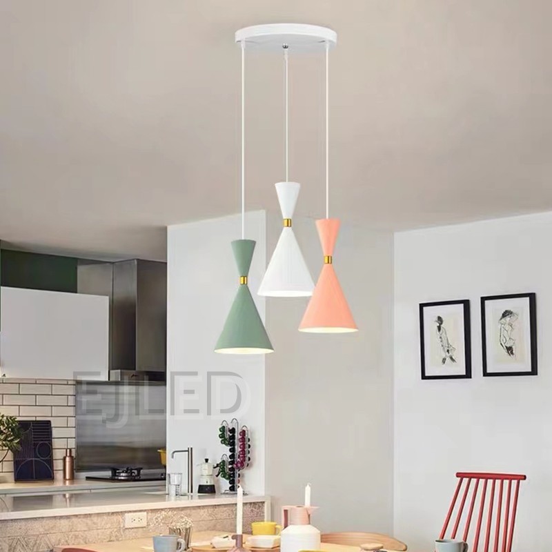 This unique pendant lamp features a black plastic body in an hourglass shape, accented by a gold-tone band. It provides downward illumination, suspended by a single cord, making it suitable for various interior settings. - view 4