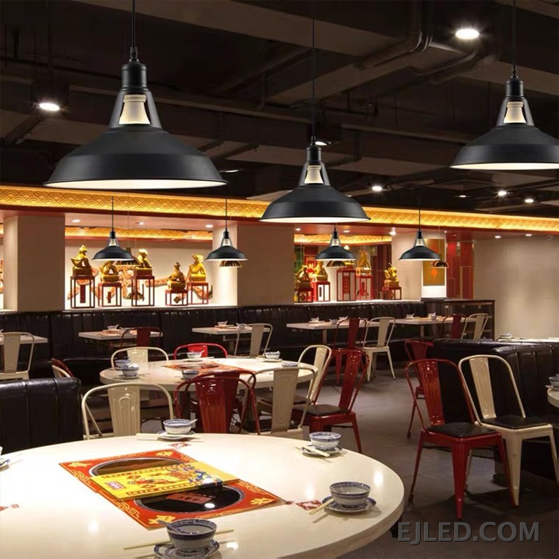 This dome pendant light features a matte black steel shade with an open bottom, revealing a single bulb and a light-colored interior for broad illumination. It hangs from a simple suspension cord. - view 6