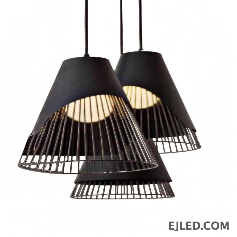 This iron pendant light features a black conical shade with an integrated open wire cage, revealing a warm, internally shielded light source. The unique layered design offers a distinctive aesthetic.