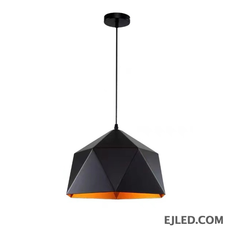 This steel pendant light features a multi-faceted geometric shade. It has a matte black exterior finish and a contrasting warm orange interior, providing downward illumination.