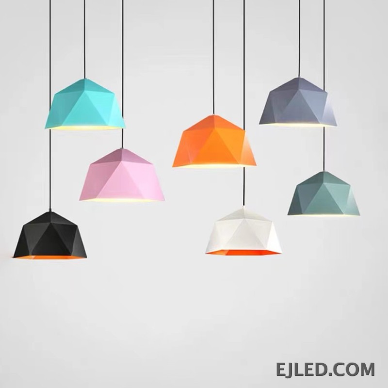 This steel pendant light features a multi-faceted geometric shade. It has a matte black exterior finish and a contrasting warm orange interior, providing downward illumination. - view 6