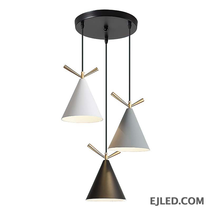 This pendant fixture features three cone-shaped metal shades in white, gray, and black, each accented with gold-colored details and an open bottom. It hangs from a single black circular canopy.
