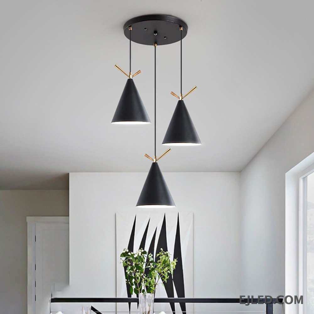 This pendant fixture features three cone-shaped metal shades in white, gray, and black, each accented with gold-colored details and an open bottom. It hangs from a single black circular canopy. - view 6