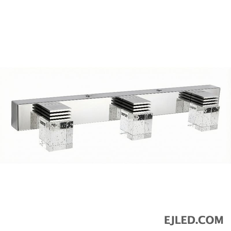 Three rectangular crystal shades in chrome-finished stainless steel and aluminum form this mirror lamp, designed to direct light outward over vanity spaces.