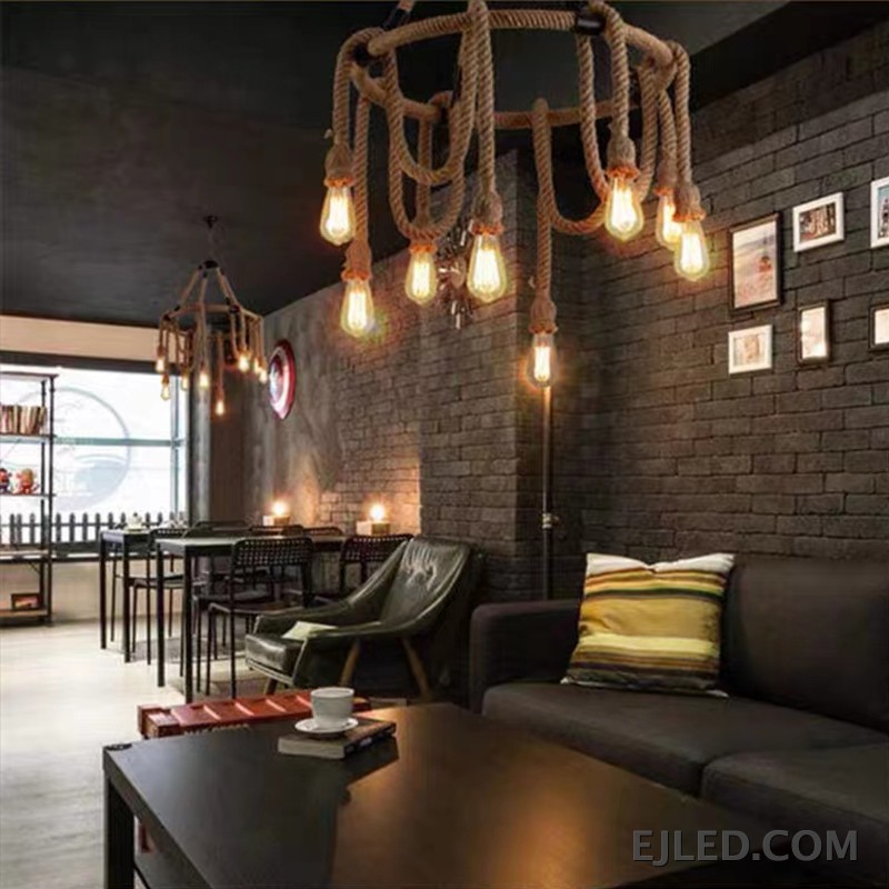 A unique hemp rope chandelier presenting five exposed glass lamps, suspended by rope from a central chain. This fixture features a natural rope finish and a rustic design. - view 2