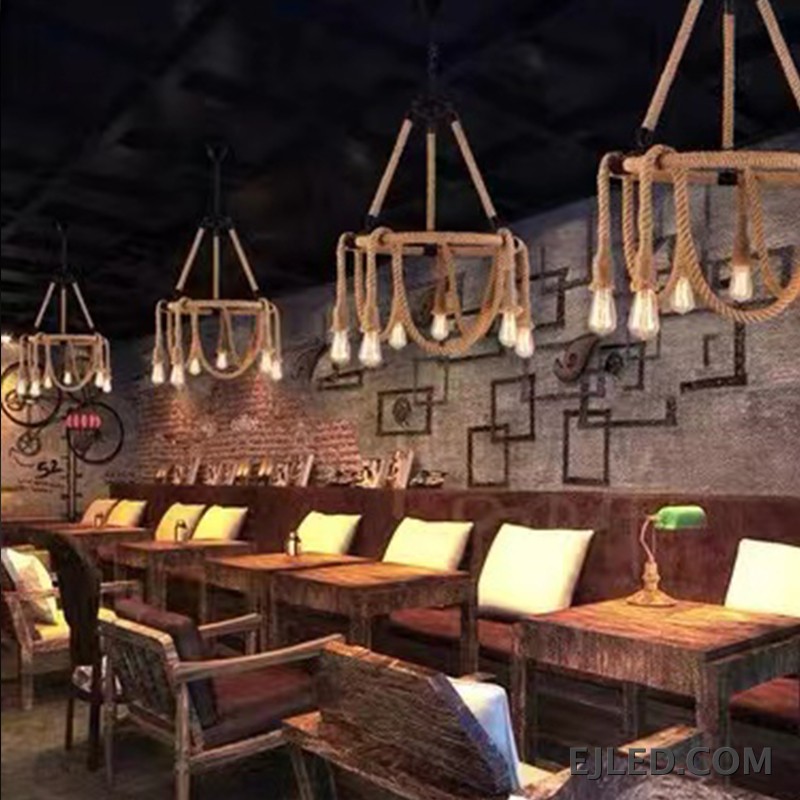 A unique hemp rope chandelier presenting five exposed glass lamps, suspended by rope from a central chain. This fixture features a natural rope finish and a rustic design. - view 6