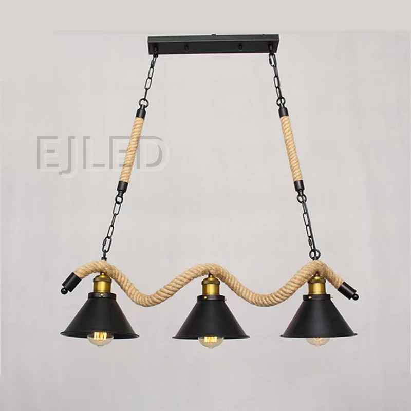 This three-light pendant features bell-shaped metal shades with a black finish, suspended along a wavy hemp rope. It hangs from a black ceiling plate via metal chains and straight ropes, offering a distinctive look. - view 4
