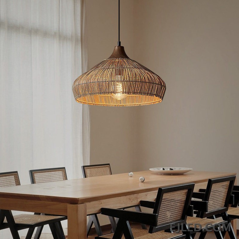 This RT0472 pendant lamp features a handwoven natural rattan shade in a flared dome shape. Its open construction allows ambient light to filter through the wicker, illuminating the single visible lamp. - view 5
