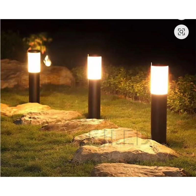 This modern cylindrical outdoor bollard light features a dark grey metal base topped with a frosted white shade, designed for path and garden illumination. Model SL0001. - view 2