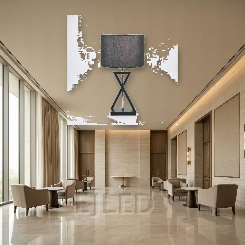 This black fabric shade table lamp features an hourglass geometric metal base in a dark finish and a central chrome support rod, blending modern lines with soft illumination for indoor spaces. - view 5