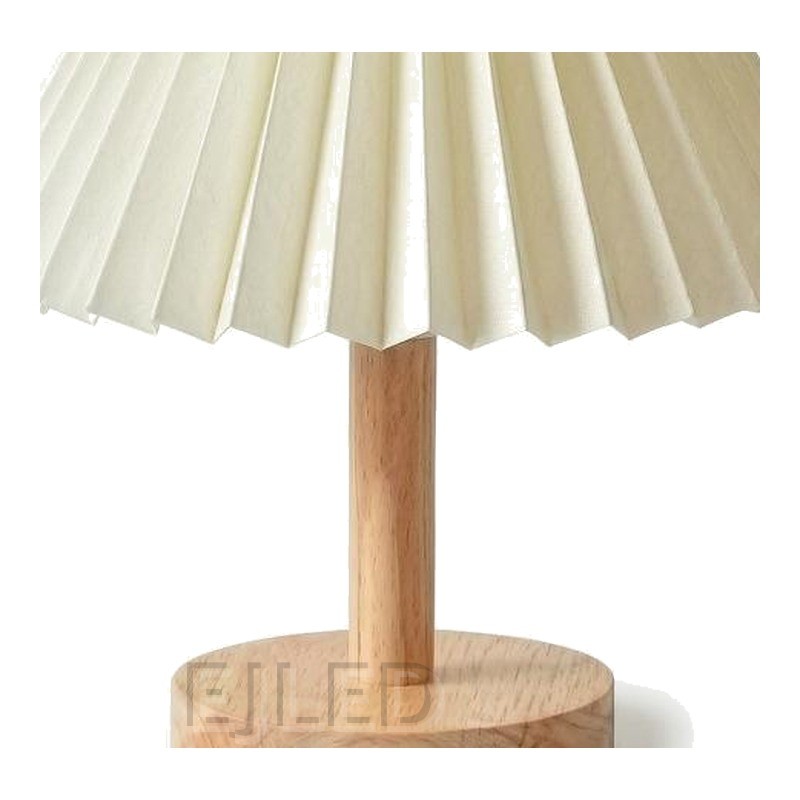 This wooden base table lamp features an off white pleated fabric shade supported by a natural wood stem and round wooden base. - view 3