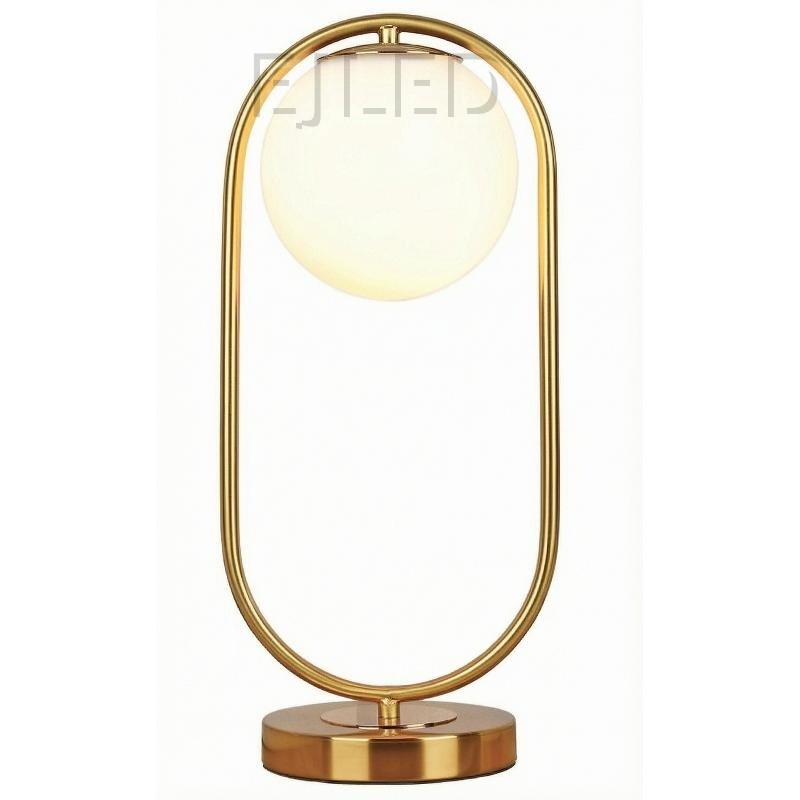This modern gold table lamp features an open metal loop frame supporting a white spherical glass shade over a round brass base.