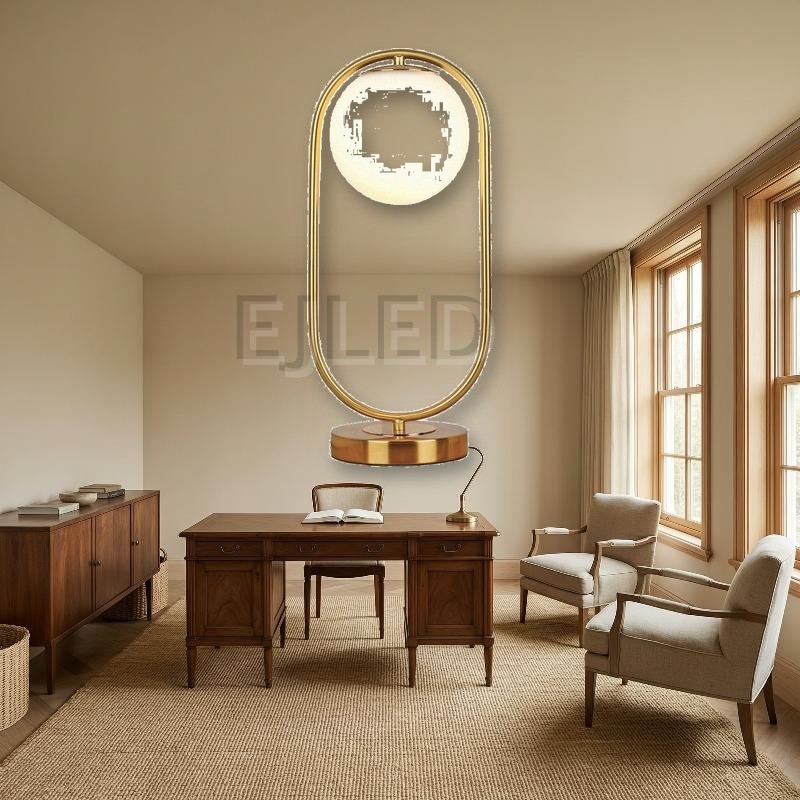 This modern gold table lamp features an open metal loop frame supporting a white spherical glass shade over a round brass base. - view 4