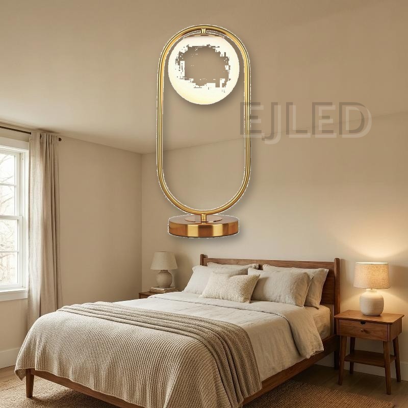 This modern gold table lamp features an open metal loop frame supporting a white spherical glass shade over a round brass base. - view 5