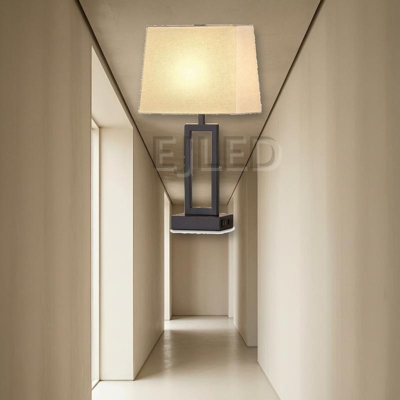 This modern table lamp features a dark metal rectangular base, an open geometric column, and a trapezoid fabric shade with built-in USB charging ports. - view 5