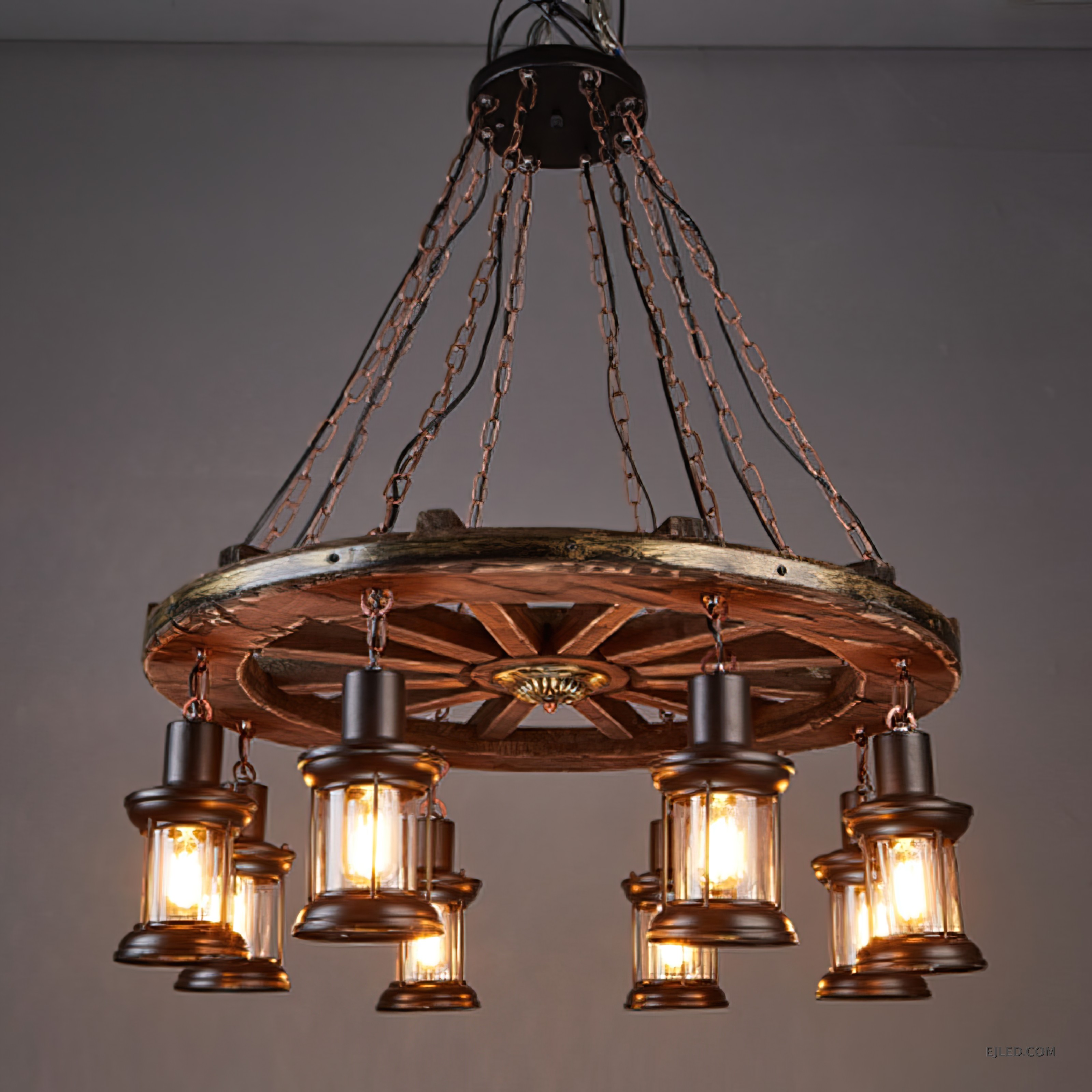 This fixture features a distressed wooden wagon wheel frame suspending eight lantern-style lights. It hangs from multiple chains, creating a rustic aesthetic suitable for various interior designs. - view 2