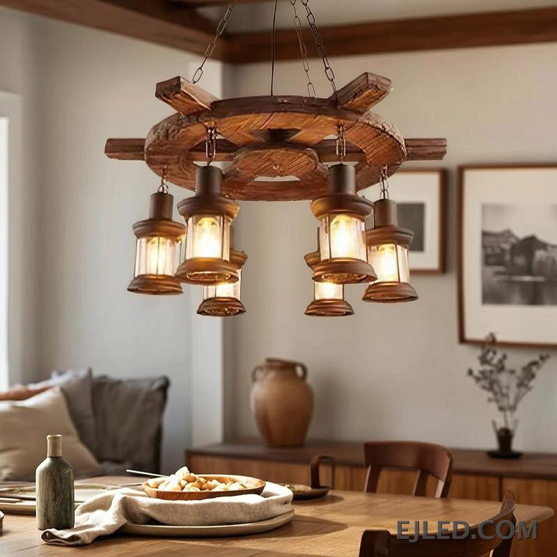 This wooden chandelier features a dark, rustic wagon wheel design with a 75cm diameter. Six clear glass lantern-style lights hang, offering an enclosed yet visible light source. - view 6