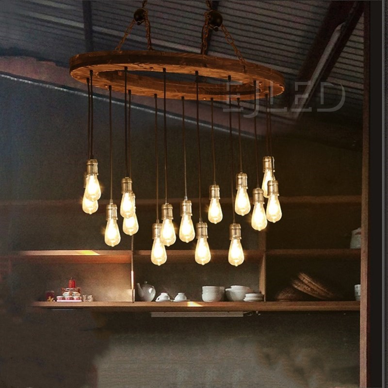 This rustic wood wheel chandelier features a circular wooden frame suspended by a chain, holding multiple hanging pendant lights with brass sockets and Edison bulbs. - view 4
