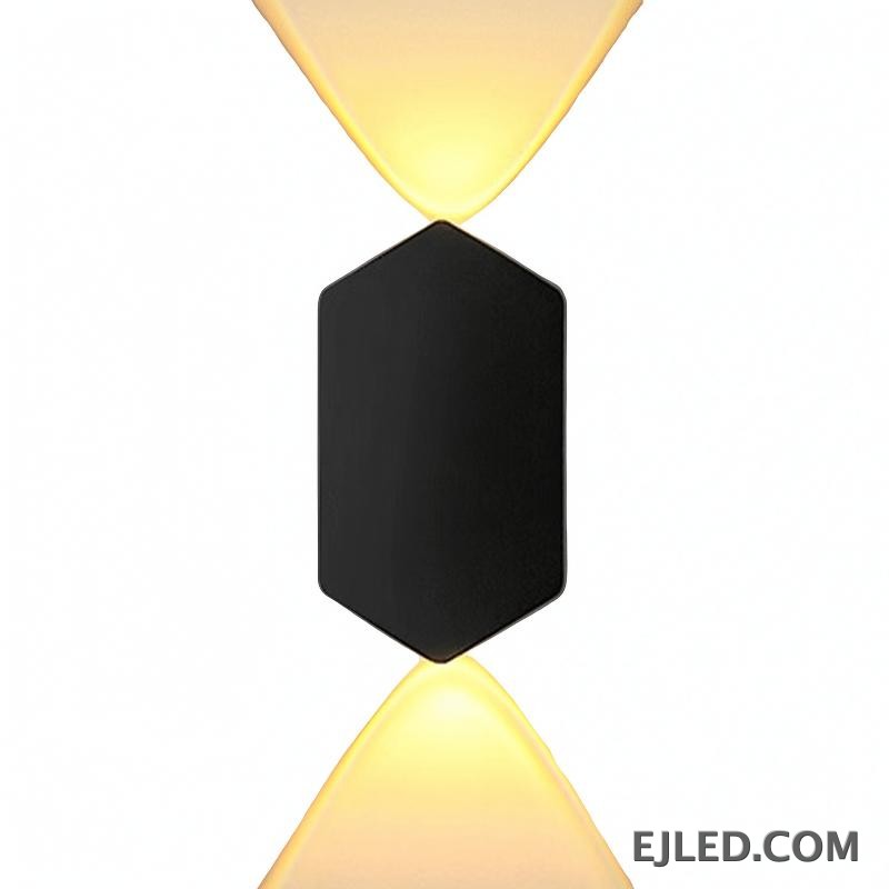 An aluminum wall light, the WL0004 features a compact, rectangular profile ideal for accent lighting in smaller areas. It projects an ambient glow from its black-finished body, suitable for subtle illumination.