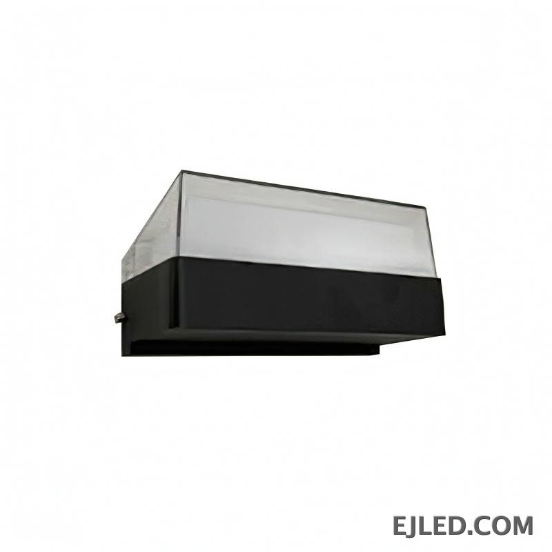 This enclosed black plastic wall light features a rectangular base and a clear sloped top diffuser, emitting soft light from its integrated source. It measures 160x85x75mm.