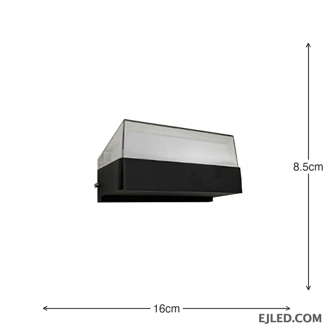 This enclosed black plastic wall light features a rectangular base and a clear sloped top diffuser, emitting soft light from its integrated source. It measures 160x85x75mm. - view 3