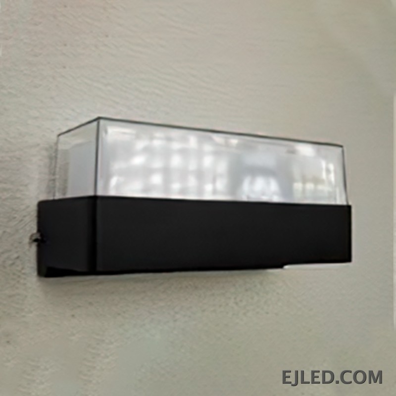 This fixture features a black rectangular plastic base topped with a clear cover enclosing a white light diffuser. It is designed for wall mounting. - view 2