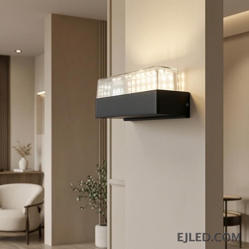 This fixture features a black rectangular plastic base topped with a clear cover enclosing a white light diffuser. It is designed for wall mounting. - view 4