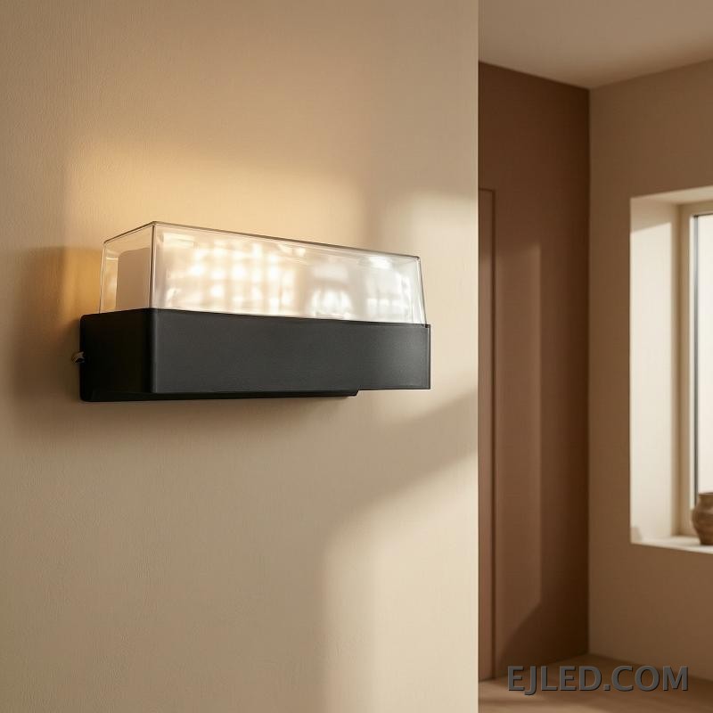 This fixture features a black rectangular plastic base topped with a clear cover enclosing a white light diffuser. It is designed for wall mounting. - view 6