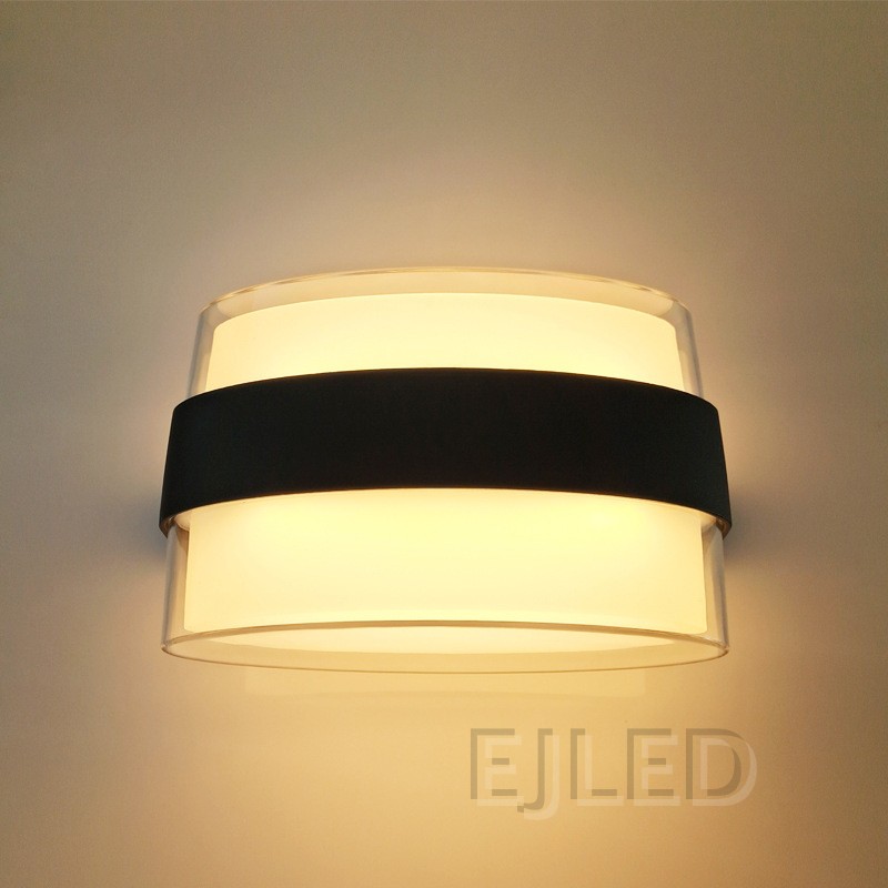 This wall light features a clear acrylic outer layer surrounding a white acrylic diffuser. A distinctive black band wraps around the middle, providing a modern and clean aesthetic for various interior settings. - view 3
