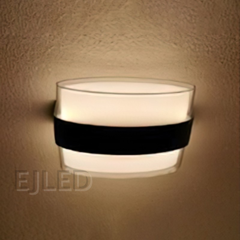 This wall light features a clear acrylic outer layer surrounding a white acrylic diffuser. A distinctive black band wraps around the middle, providing a modern and clean aesthetic for various interior settings. - view 4