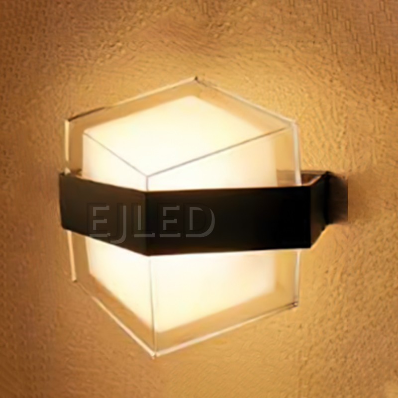 This hexagonal acrylic wall light features a clear outer shade, a white internal diffuser, and a distinct dark band around its middle. It provides enclosed illumination from a wall-mounted fixture. - view 2