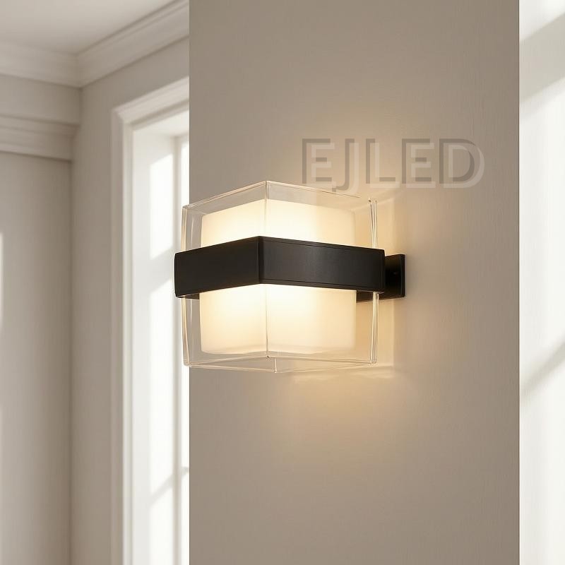 This hexagonal acrylic wall light features a clear outer shade, a white internal diffuser, and a distinct dark band around its middle. It provides enclosed illumination from a wall-mounted fixture. - view 5