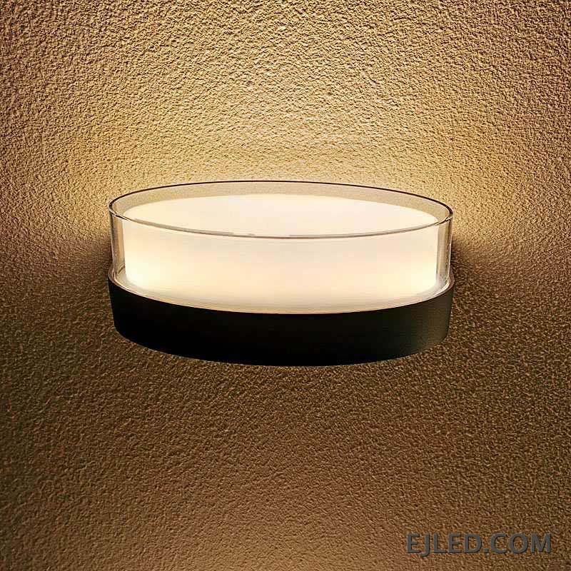 This round light fixture features a clear glass cylinder encasing a diffused white light, set upon a dark, circular base. It measures 185x80x85MM. - view 2