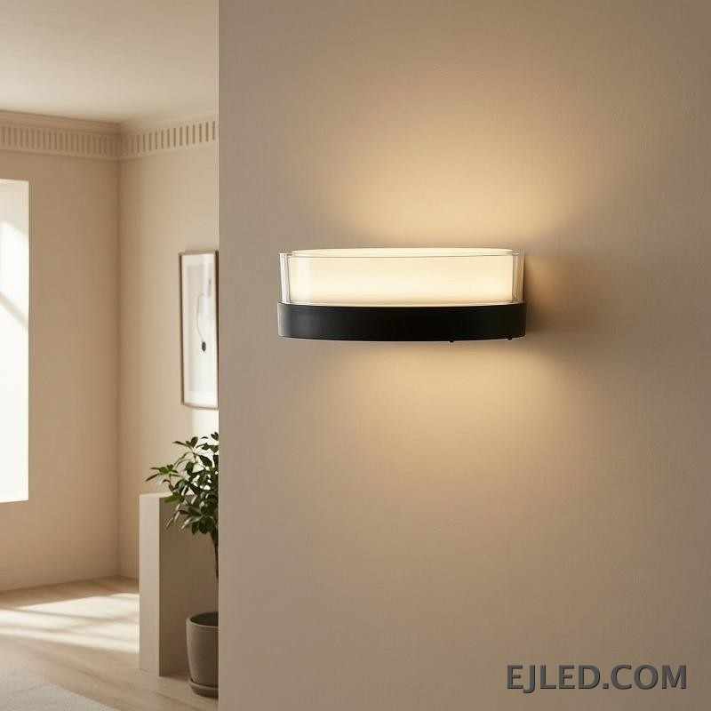 This round light fixture features a clear glass cylinder encasing a diffused white light, set upon a dark, circular base. It measures 185x80x85MM. - view 5