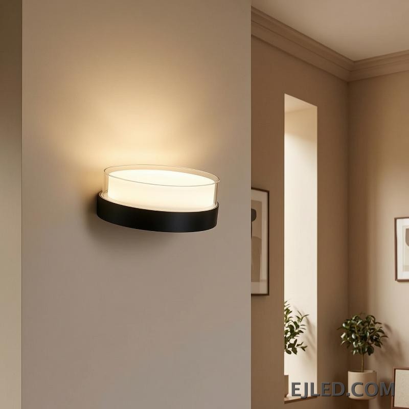 This round light fixture features a clear glass cylinder encasing a diffused white light, set upon a dark, circular base. It measures 185x80x85MM. - view 6