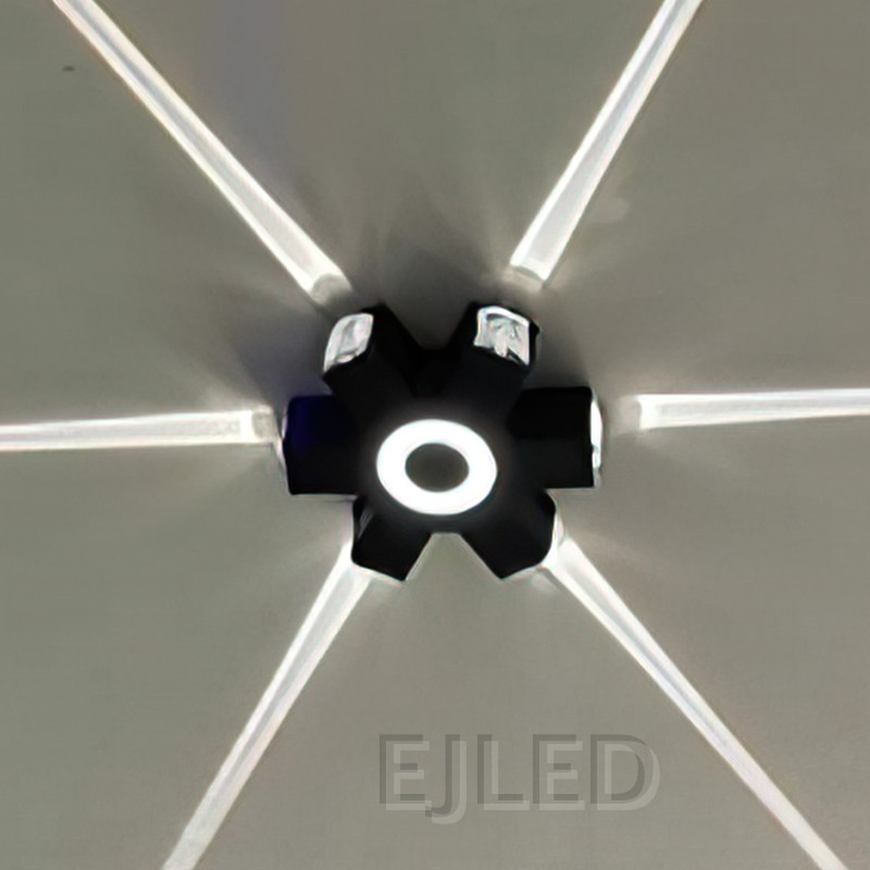 Este aplique de pared de aluminio negro presenta un cuerpo rectangular con un elemento circular luminoso central y extremos de montaje expuestos, creando una silueta moderna distintiva. - view 6
