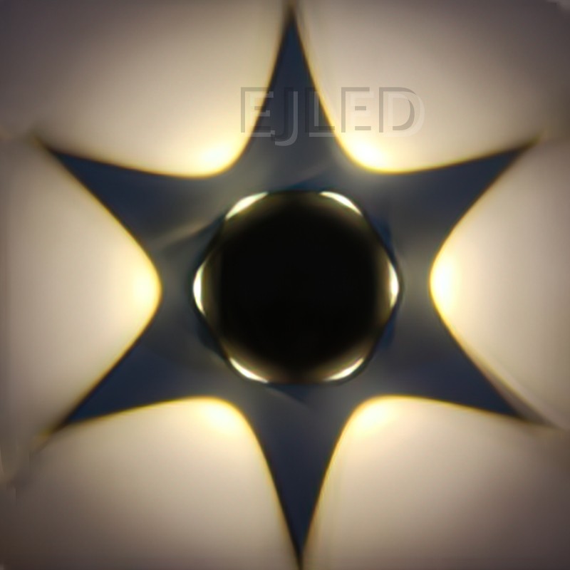 This wall light features a dark star-shaped plastic body with a central black sphere and warm backlighting. Model WL0023. - view 2