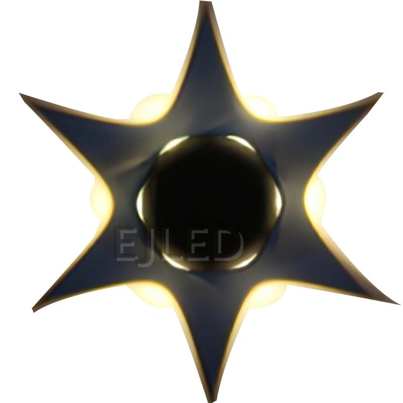 This wall light features a dark star-shaped plastic body with a central black sphere and warm backlighting. Model WL0023. - view 3
