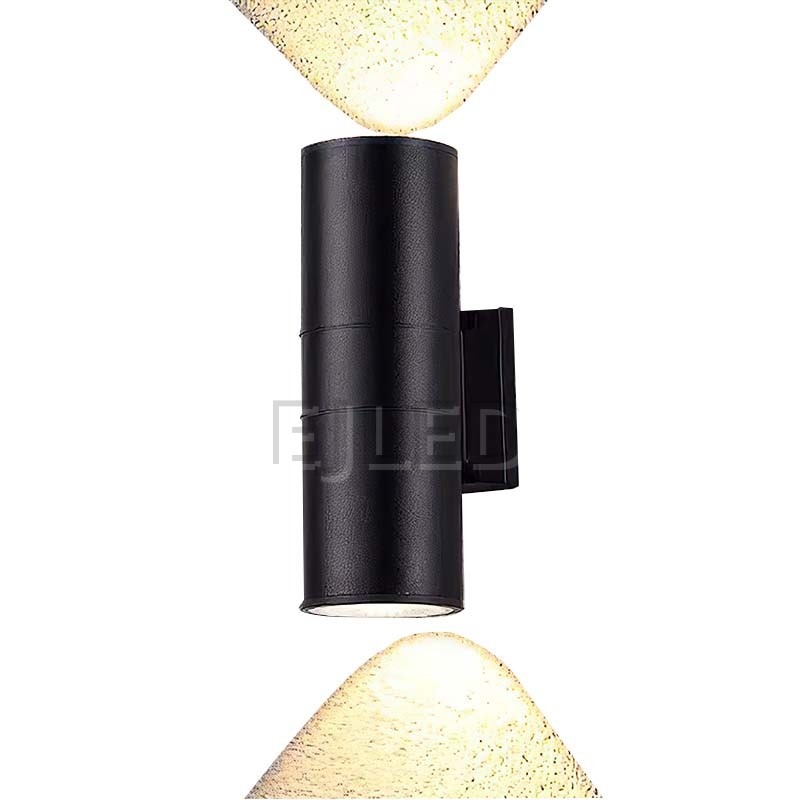 This black aluminum cylindrical wall light features a tubular body mounted on a matching rectangular wall bracket, directing illumination downward. - view 3