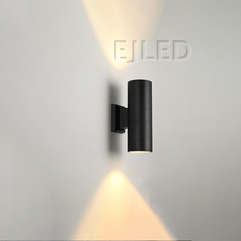 This black aluminum cylindrical wall light features a tubular body mounted on a matching rectangular wall bracket, directing illumination downward. - view 6